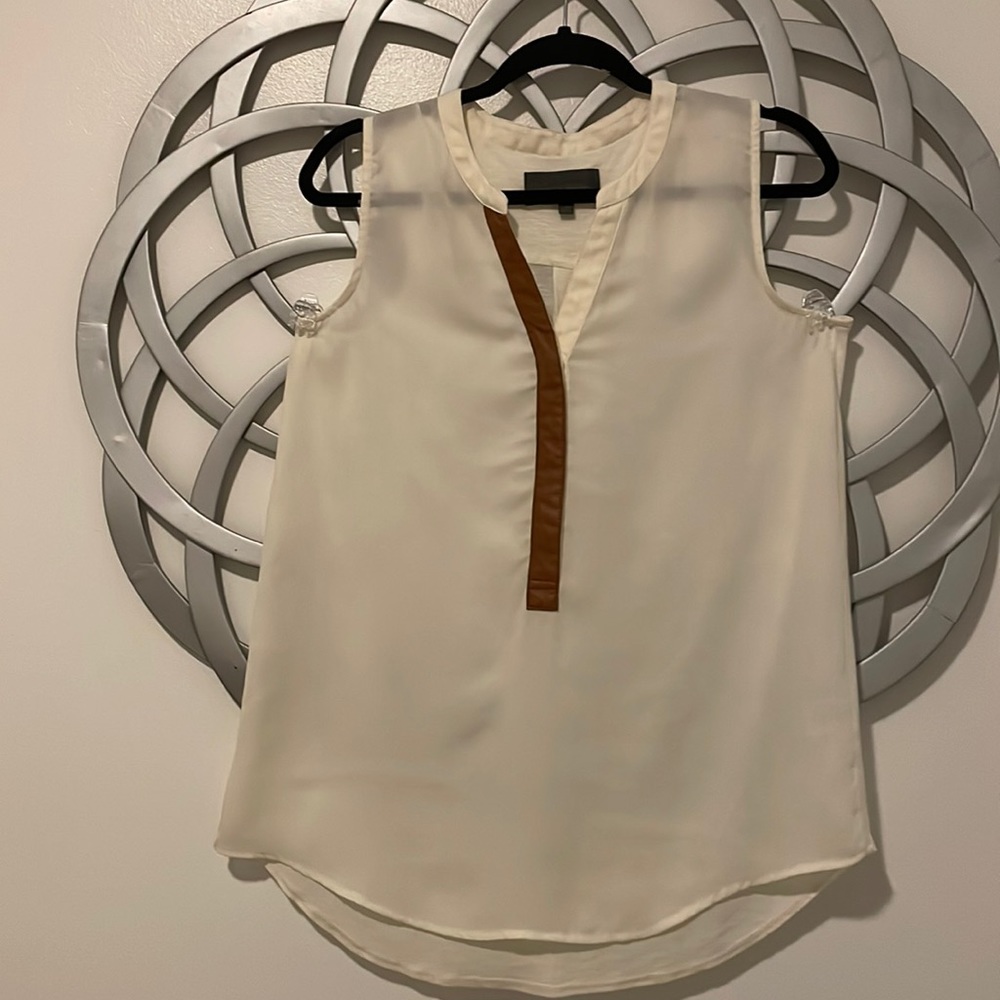 Cream sleeveless top.